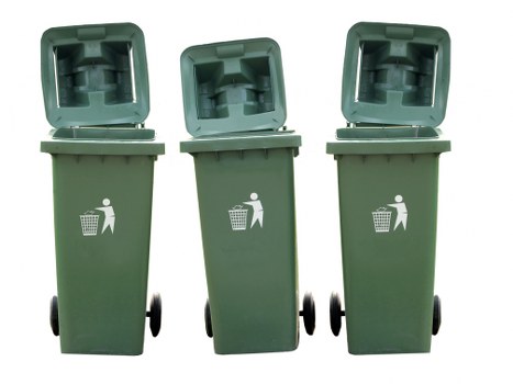Three green wheeled rubbish bins with open lids, positioned outdoors on a paved surface, likely within a residential or commercial premises in the Golders Green area. The bins are made of durable plastic with a slightly textured surface and have matching white icons of a person disposing of waste printed on the front. They are aligned in a row, with the leftmost bin slightly angled to the right, and the middle and right bins facing forward. The background is plain white, emphasizing the bins and their details. The environment suggests a typical waste collection setup for rubbish disposal services in London or nearby suburbs, relevant to the services offered by Commercial Waste Golders Green, especially for front-of-property or street-side waste management and removal. The image conveys a standard scene associated with waste and rubbish collection for both residential and small commercial premises, reflecting an efficient and organized approach to waste management in the area.